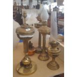 THREE BRASS OIL LAMPS WITH REEDED COLUMNAR SUPPORTS, & ANOTHER (4).