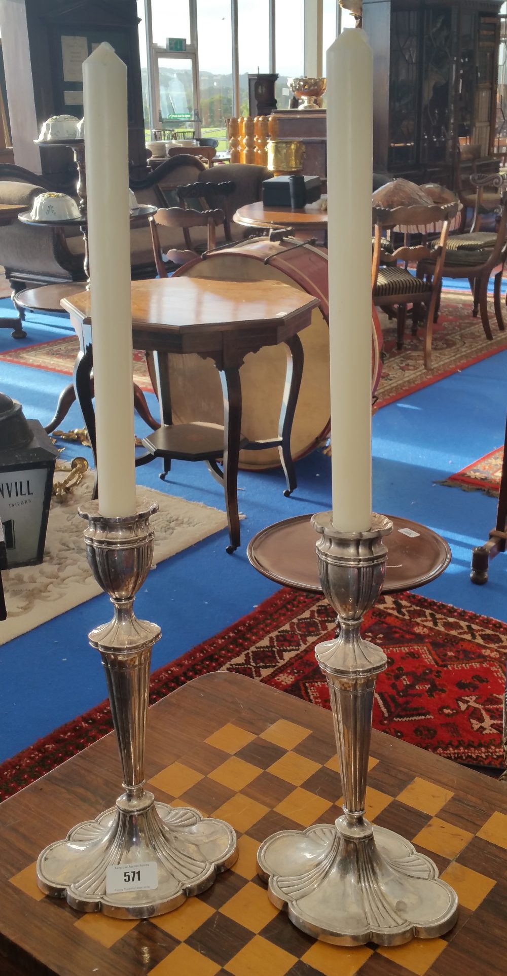 A LOVELY PAIR OF SILVER PLATED CANDLESTICKS.