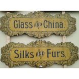 A PAIR OF SIGNS 'GLASS AND CHINA' AND 'SILKS AND FURS'.