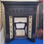 A GOOD BLACK CAST IRON FIREPLACE with tiled interior.