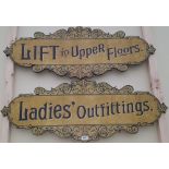 A PAIR OF SIGNS 'LIFT TO UPPER FLOORS' AND 'LADIES OUTFITTERS'.