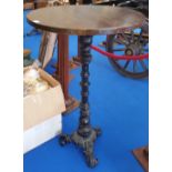 A BAR HIGH TABLE on cast iron decorative tripod base.