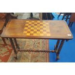 A WALNUT AND SATINWOOD VENEERED GAMES TABLE with bobbin turned supports and stretcher, late 19th/