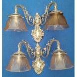 A LOVELY PAIR OF BRASS BACKED TWIN BRANCH WALL LIGHTS silvered, with glass shades.