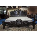 A LOVELY MAHOGANY DOUBLE BED with moulded supports, highly carved. (Dorian's Bed).