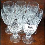 A MATCHED SET OF NINE WATERFORD CRYSTAL PORT GLASSES.