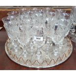 A GOOD SUITE OF EIGHTEEN WHITE WINE GLASSES & CIRCULAR SILVER-PLATE TRAY.