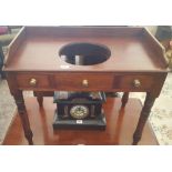 A 19TH CENTURY MAHOGANY SIDE TABLE with wash bowl top and twin drawers.