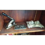 A SILVER-PLATE DESK STAND WITH TWO GLASS INKWELLS, along with a Victorian cast embossing letter