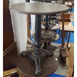 A CIRCULAR BAR TABLE with a cast iron pedestal and base.