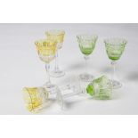 FIFTEEN CUT GLASS COLOURED WINE GLASSES.