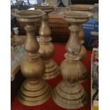 FOUR VERY HEAVY BRASS CANDLESTICKS of large proportions.