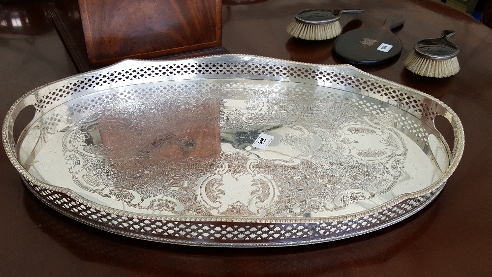 A LOVELY LARGE OVAL SILVER PLATED SERVING TRAY with pierced sides, 2ft wide.