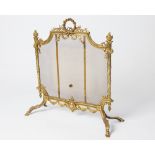 A LATE 19TH, EARLY 20TH CENTURY BRASS SPARK GUARD with mesh interior, the ornate frame topped with