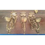 A GOOD GROUP OF THREE EARLY 20TH CENTURY WALL SCONCES with lion head backs.