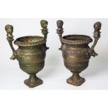 A FABULOUS PAIR OF CAST IRON URNS.