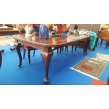 A GOOD 20TH CENTURY MAHOGANY EXTENDING DINING TABLE with two leaves on cabriole legs with large