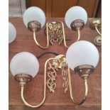 A LOVELY PAIR OF TWIN BRANCH BRASS WALL LIGHTS with glass dome shades.