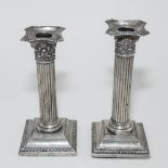 CORINTHIAN COLUMN SILVER CANDLESTICKS: A Near Pair of Silver Candlesticks, with classical columns