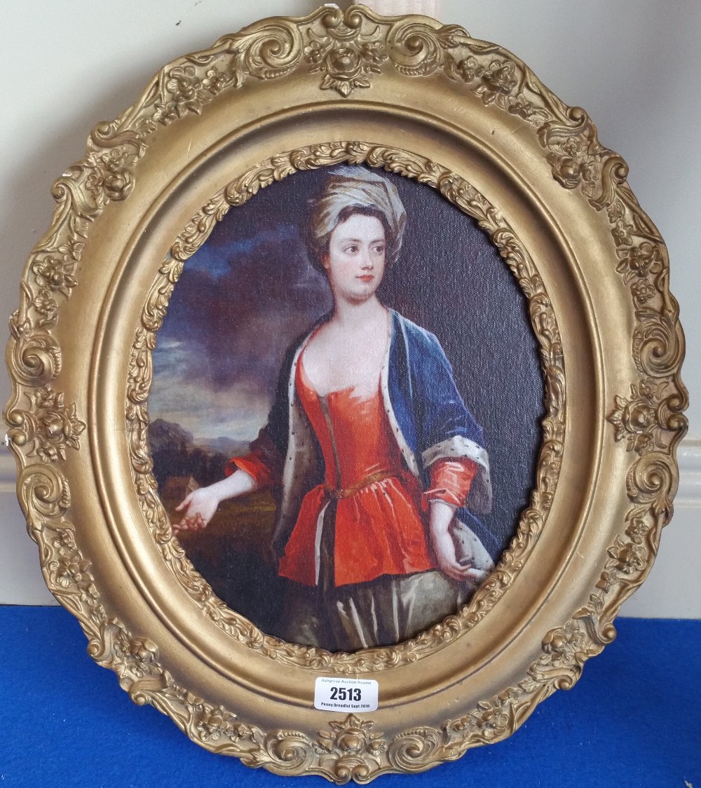 A.T.O. A SMALL OVAL GILT FRAMED PRINT of a woman. 15.5" x 18".