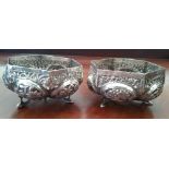 A PAIR OF MATCHED INDIAN SILVER FOOTED BOWLS, each with stylised foliate and animal motifs, 155g