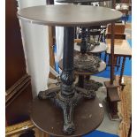 A CIRCULAR BAR TABLE with a cast iron pedestal and base.