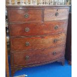 A 19TH CENTURY MAHOGANY BOW FRONT CHEST OF DRAWERS with two short over three long with brass ring