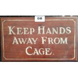 A 'KEEP HANDS AWAY FROM CAGE' SIGN along with two balcony signs.