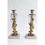 A PAIR OF ORMOLU CANDLESTICKS, each of a standing classical robed maiden supporting a single