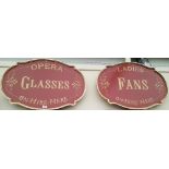 A PAIR OF SIGNS 'OPERA GLASSES' AND 'LADIES FANS ON HIRE HERE'.