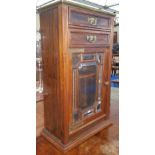 A LATE 19TH CENTURY ROSEWOOD WALL MOUNTED CABINET with bevelled glass door under two drawers,