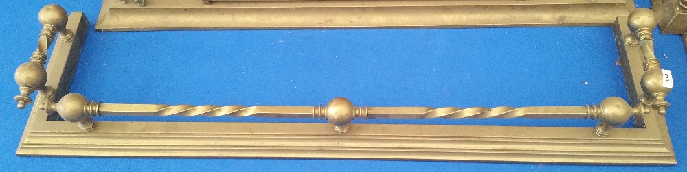 A GOOD 19TH CENTURY BRASS FENDER with twisted rails.