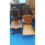 A GROUP OF THREE HALL CHAIRS highly carved, to include a late 19th century oak example.