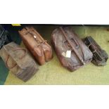 A GROUP OF FOUR LEATHER AND CARPET TRAVELLING BAGS.