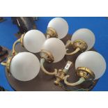 A SET OF SIX TWIN BRANCH BRASS WALL LIGHTS with glass dome shades.