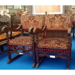 A VERY IMPRESSIVE PAIR OF OAK FRAMED THRONE CHAIRS highly carved and upholstered in red and gold