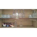 SIX VARIOUS WHISKEY DECANTERS & ASSORTED GLASSES ON TWO SHELVES.