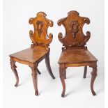 A VERY GOOD PAIR OF LATE 19TH CENTURY MAHOGANY HALL CHAIRS with a shaped and carved back.