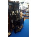 AN EARLY 20TH CENTURY EBONISED SIDE CABINET with a frieze drawer above a pair of panelled doors