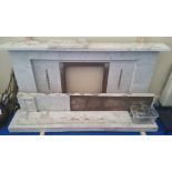 AN EARLY 20TH CENTURY WHITE MARBLE AND BRASS FIREPLACE.