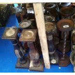 A LARGE GROUP OF VARIOUS TIMBER CANDLE HOLDERS.