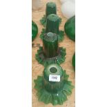 A SET OF FOUR GREEN GLASS SHADES with flared rims.