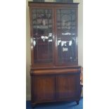 A GEORGIAN MAHOGANY TWO DOOR BOOKCASE with astragal glazed upper doors and panelled lower.