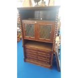 A MODERN OAK DISPLAY/TV CABINET with barley twist mouldings, three drawers to the bottom and doors