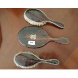 A PAIR OF SILVER MOUNTED BRUSHES WITH FAUX TORTOISESHELL HANDLES, together with a hand mirror with