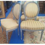 A REALLY GOOD SET OF NINE PAINTED DINING CHAIRS with striped yellow fabric. (With label reading '