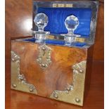 A BURR WALNUT CAMPAIGN DRINKS CADDY with two fitted bottles and with brass mounts. (Sir Malcolm's