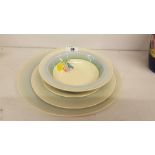 A Clarice Cliff Newport Pottery Dinner Plate; with two side plates and a soup bowl.