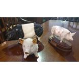 A Beswick Pig on a Stand; along with two more.