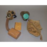 Two WW2 gas masks together with an Air Raid Precautions Handbook (3)